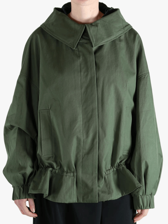 Green jacket worn by a person, showing the jacket's fit