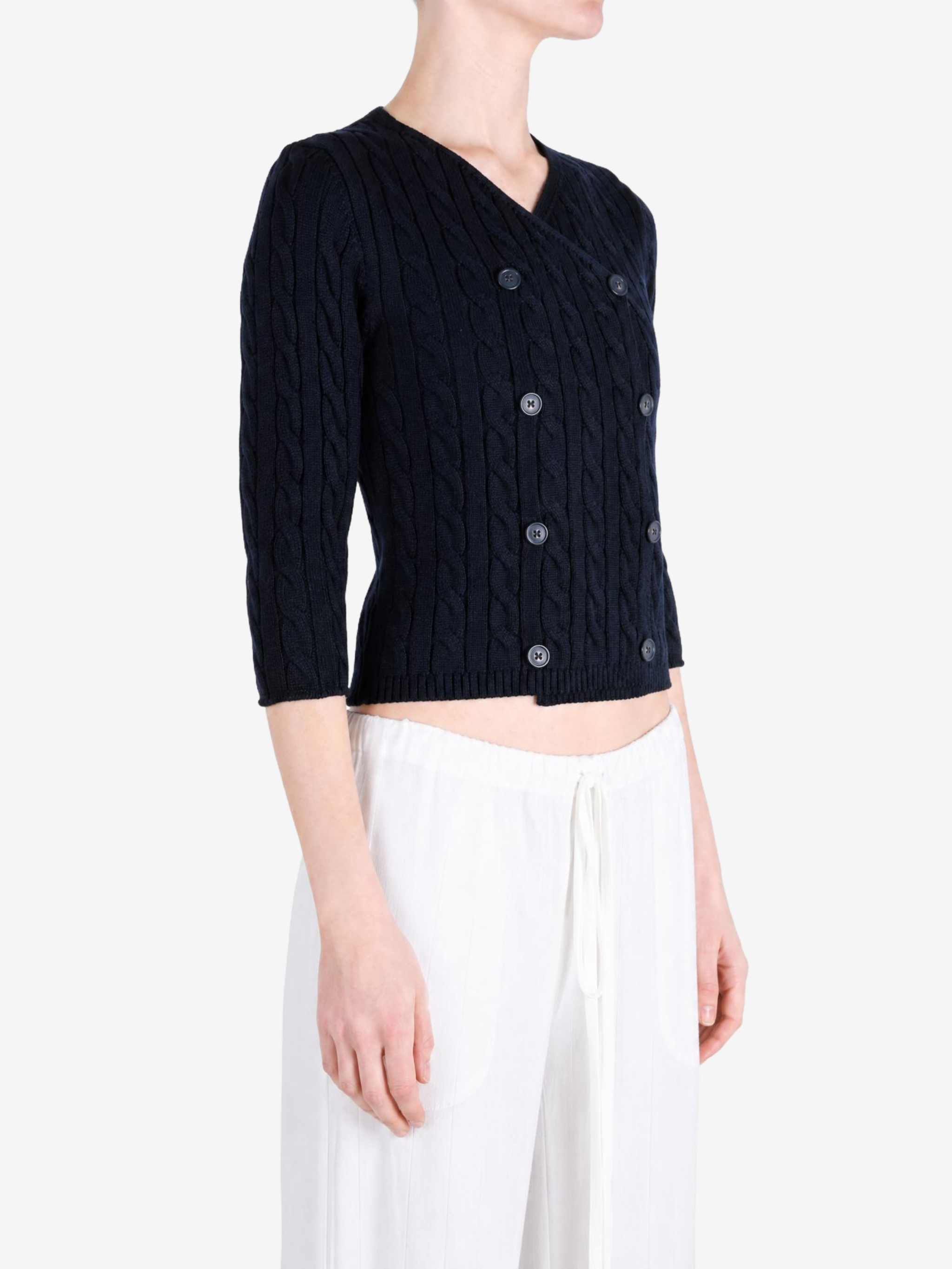 Black knitwear worn by a person, showing the knitwear fit