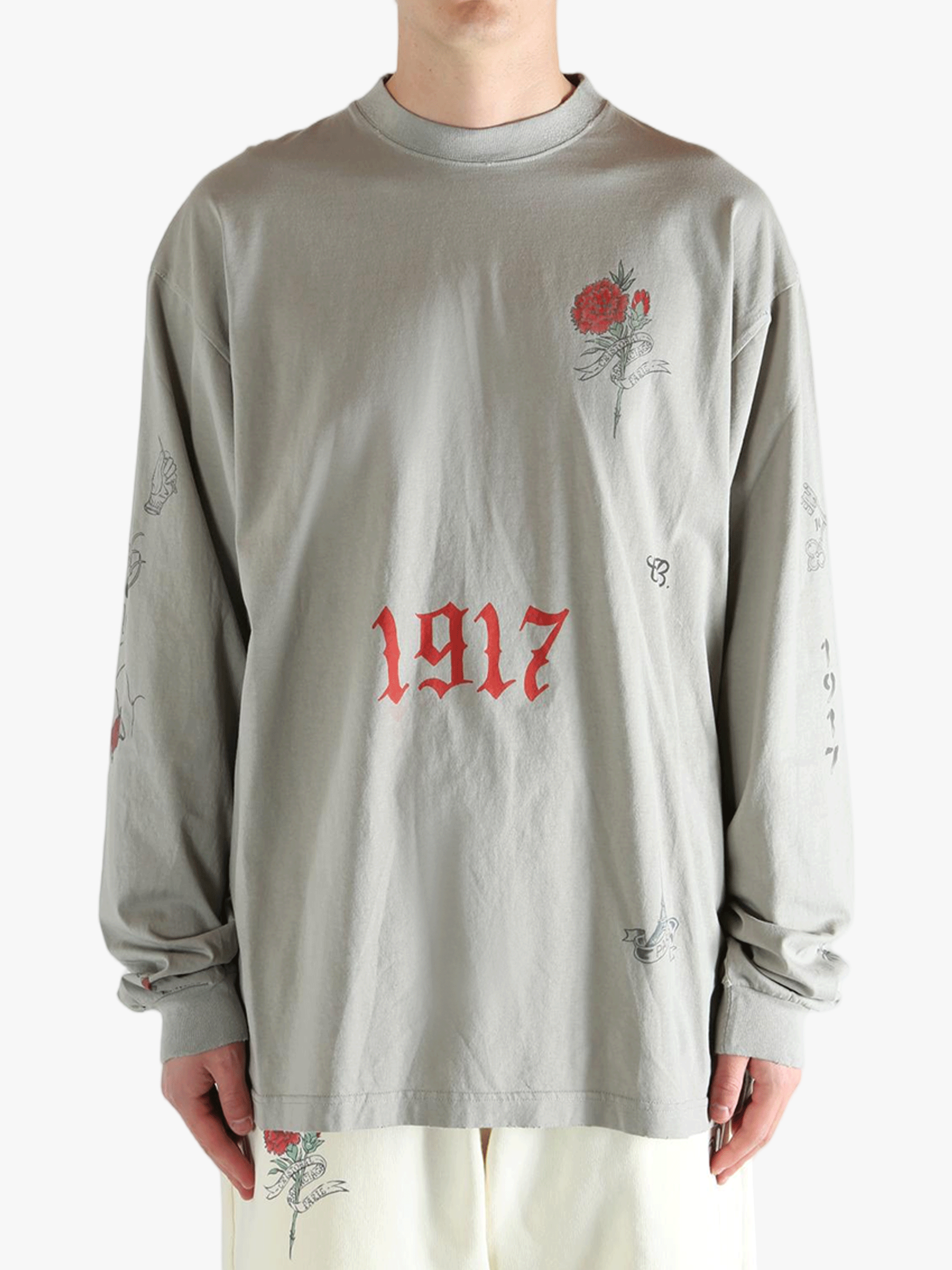 Grey tops worn by a person, showing the top fit