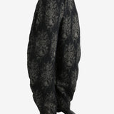 Black pants worn by a person, showing the pants's fit