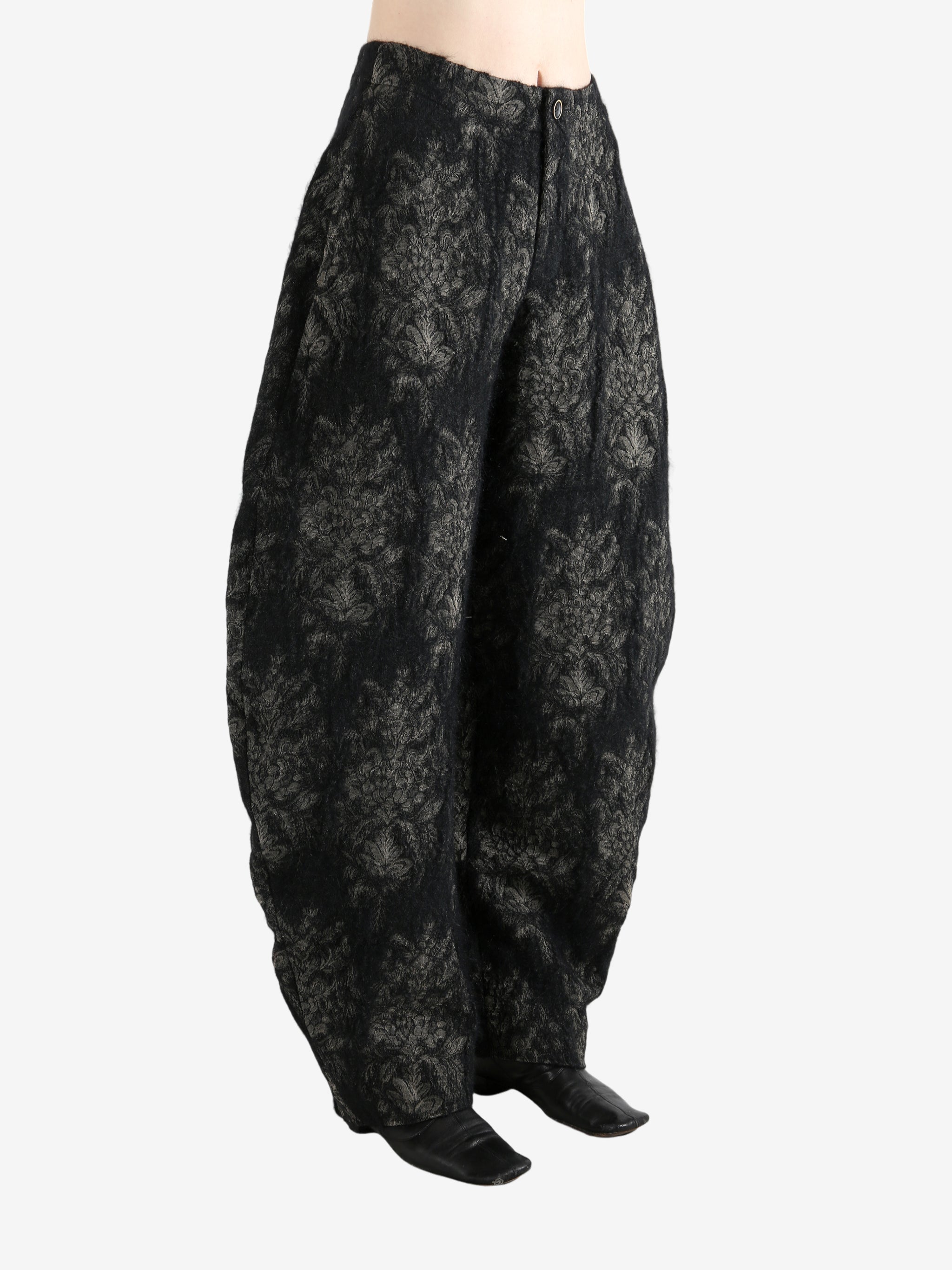 Black pants worn by a person, showing the pants's fit