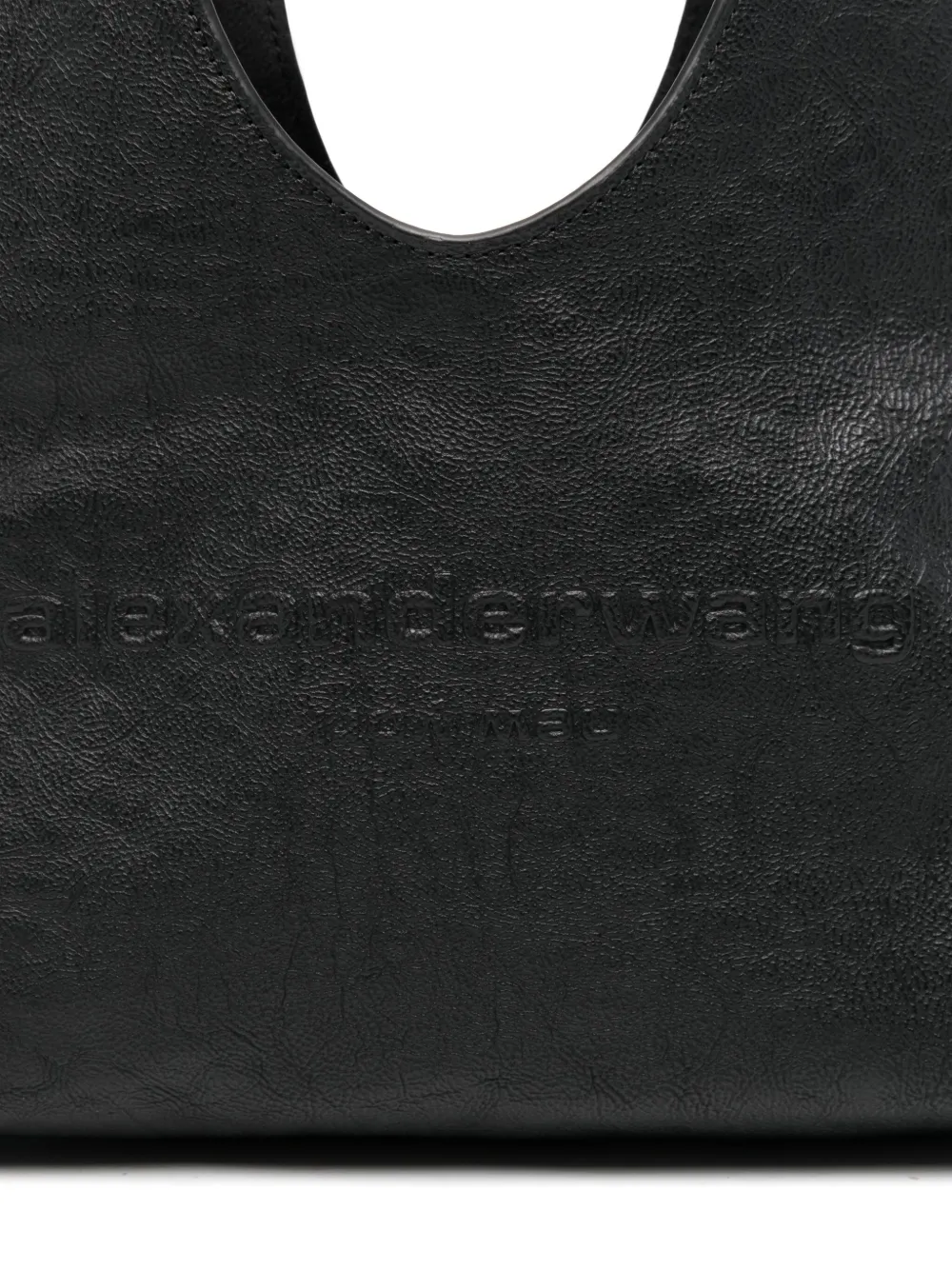 Close up of black bag,showing texture of the leather fabric.