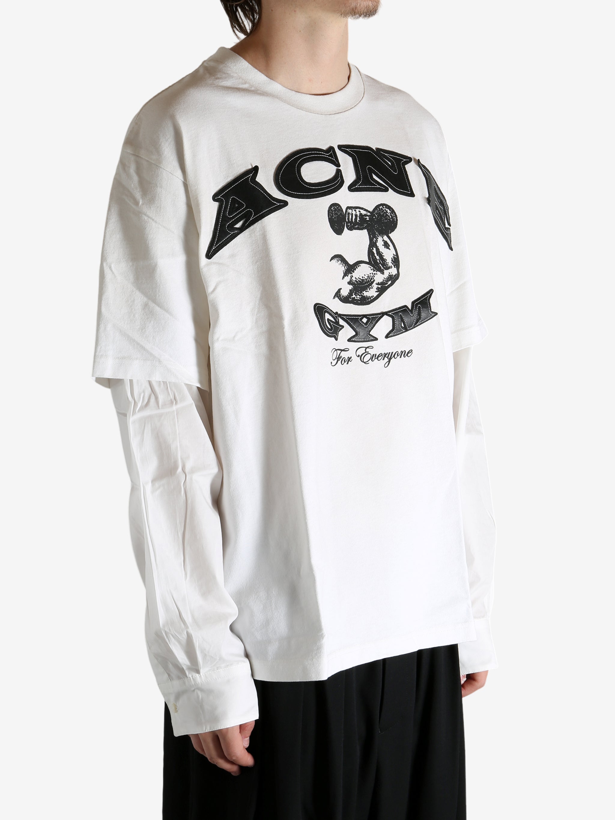 White T-shirt worn by a person, showing the T-shirt's fit