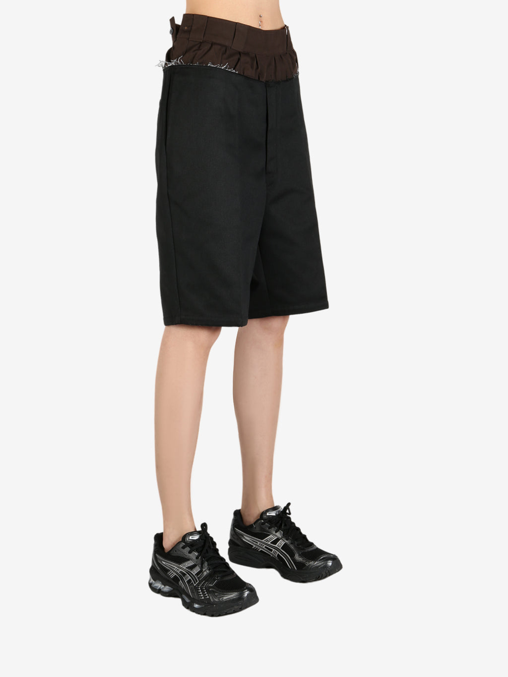 Black pants worn by a person, showing the pant’s fit