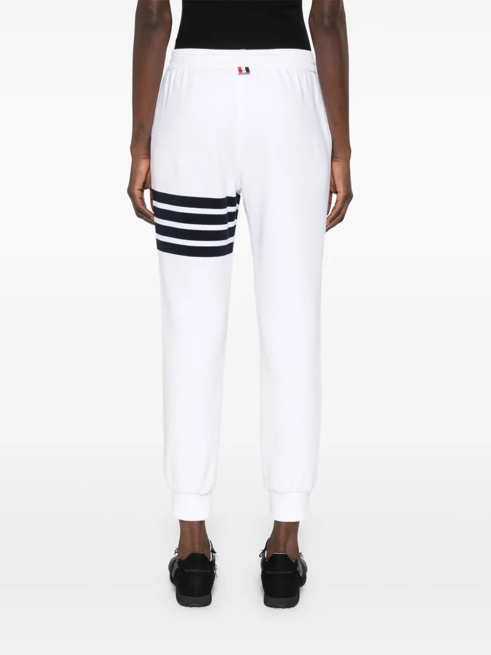 White pants worn by a person, showing the pants fit