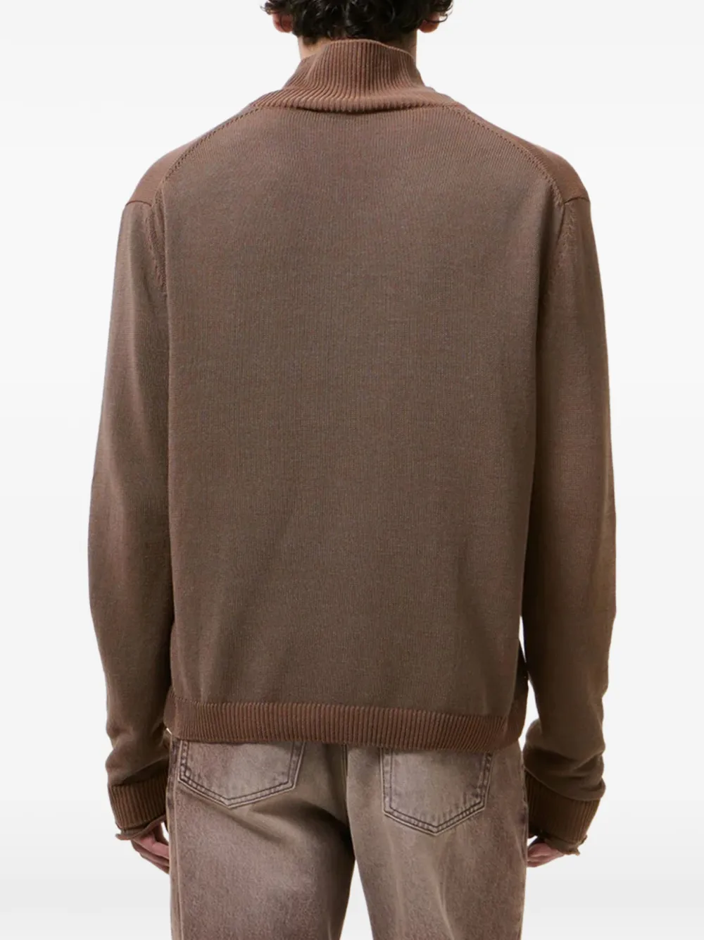 Brown sweater  by a person, showing the sweater fit