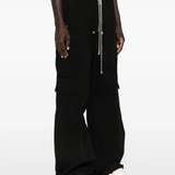 Black pants worn by a person, showing the pants' fit