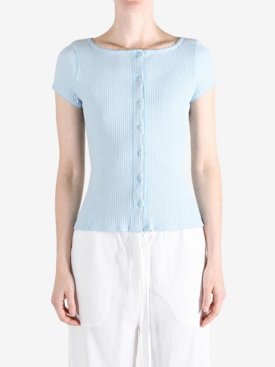 Blue knitwear worn by a person, showing the knitwear fit