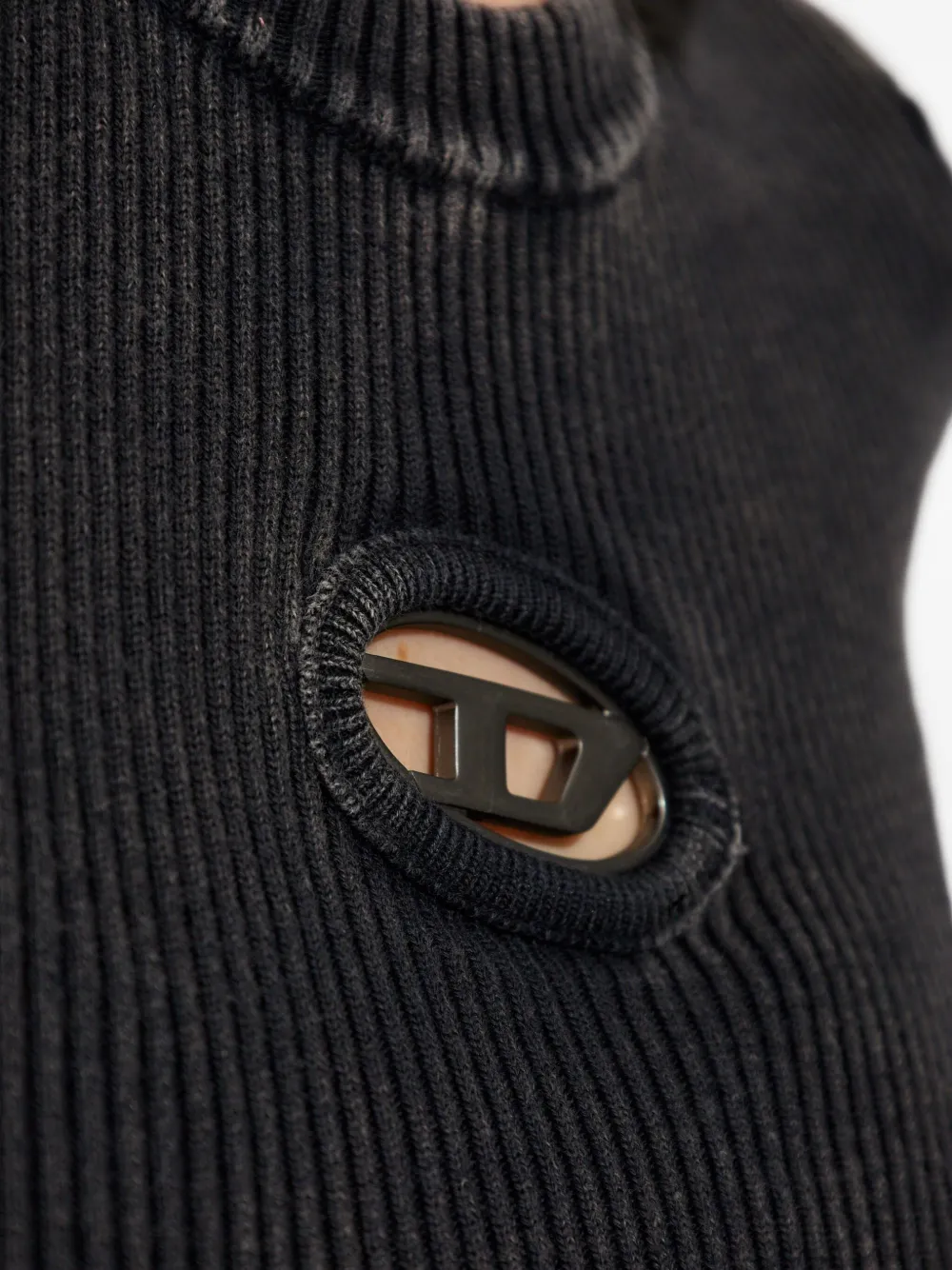Close up of black knitwear, showing texture of the Cotton fabric
