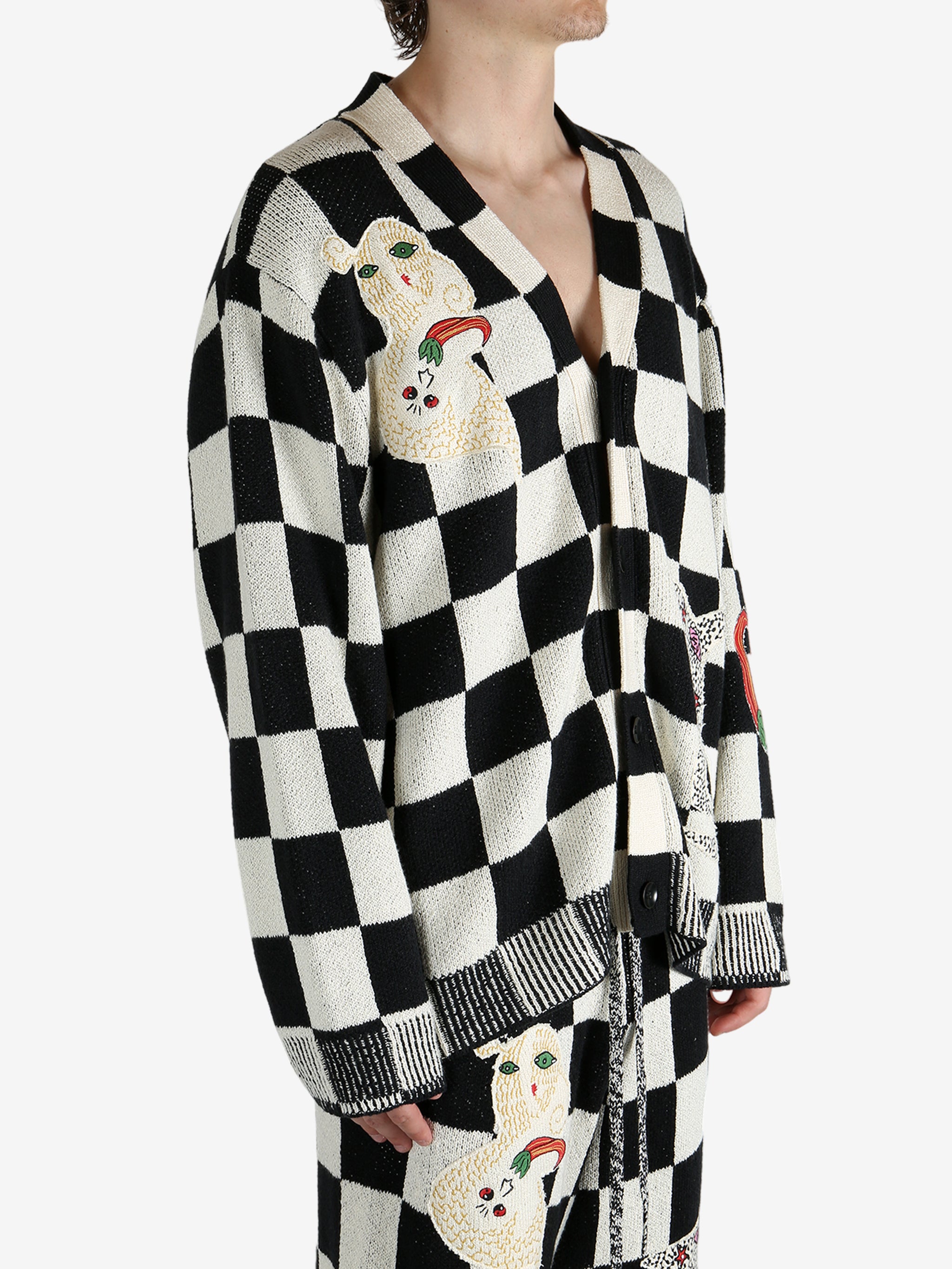 Black cardigan worn by a person, showing the cardigan’s fit