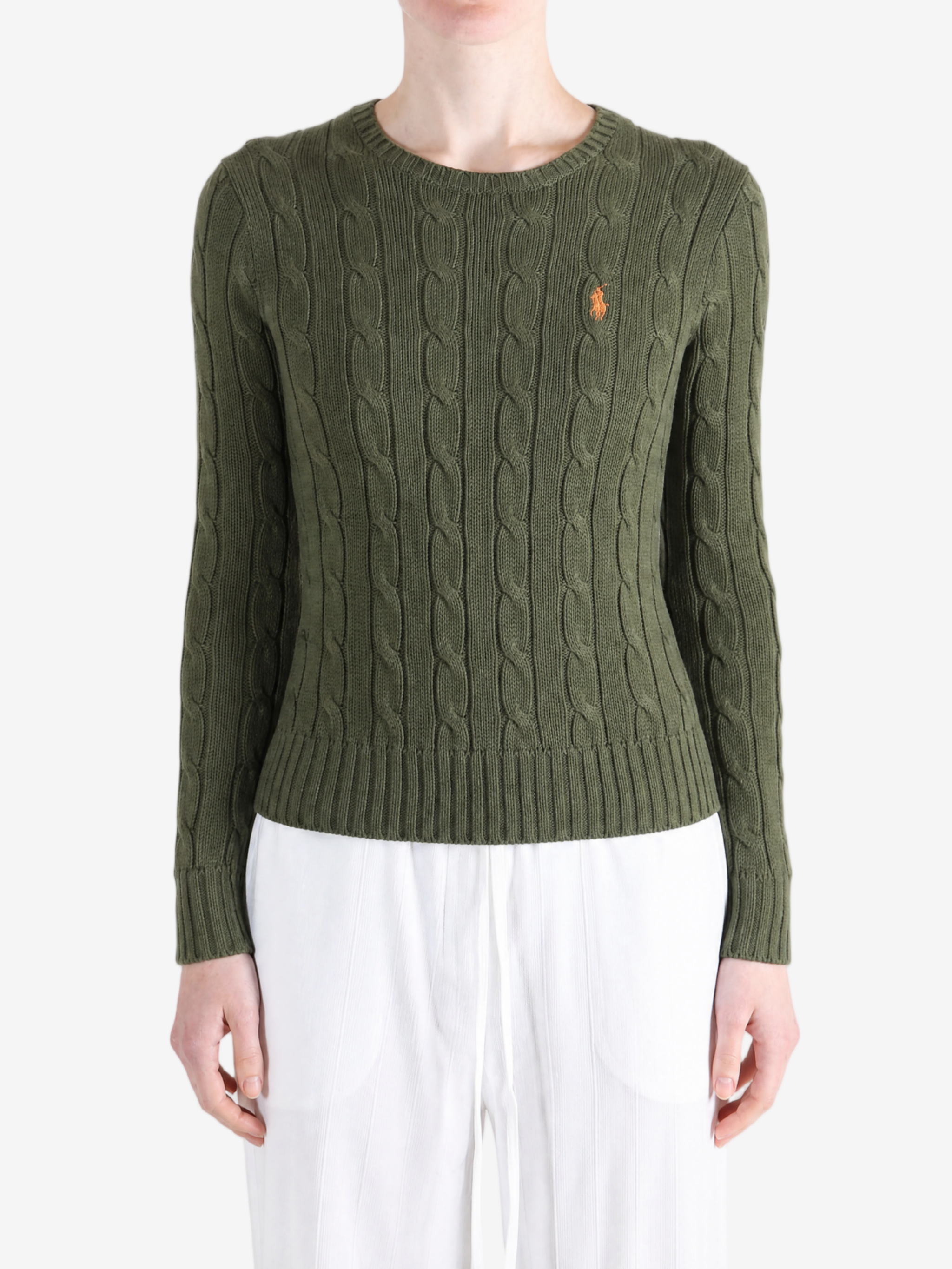 Green knitwear worn by a person, showing the knitwear fit