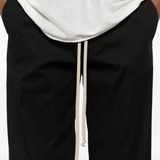 Black pants worn by a person, showing the pants fit