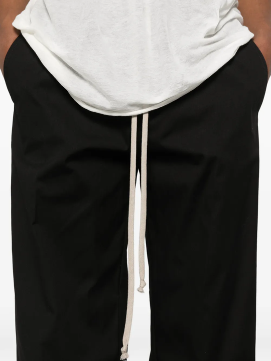 Black pants worn by a person, showing the pants fit