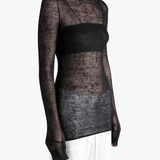 Black top worn by a person, showing the top fit