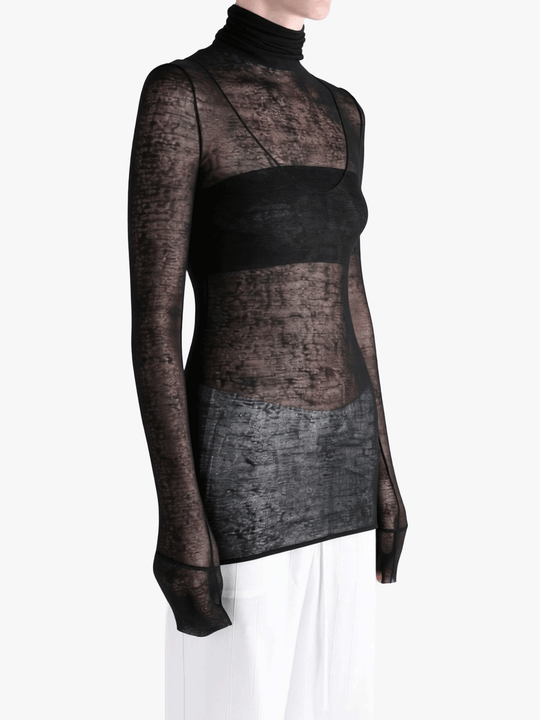 Black top worn by a person, showing the top fit