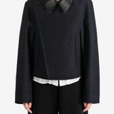 Black jacket worn by a person, showing the jacket fit