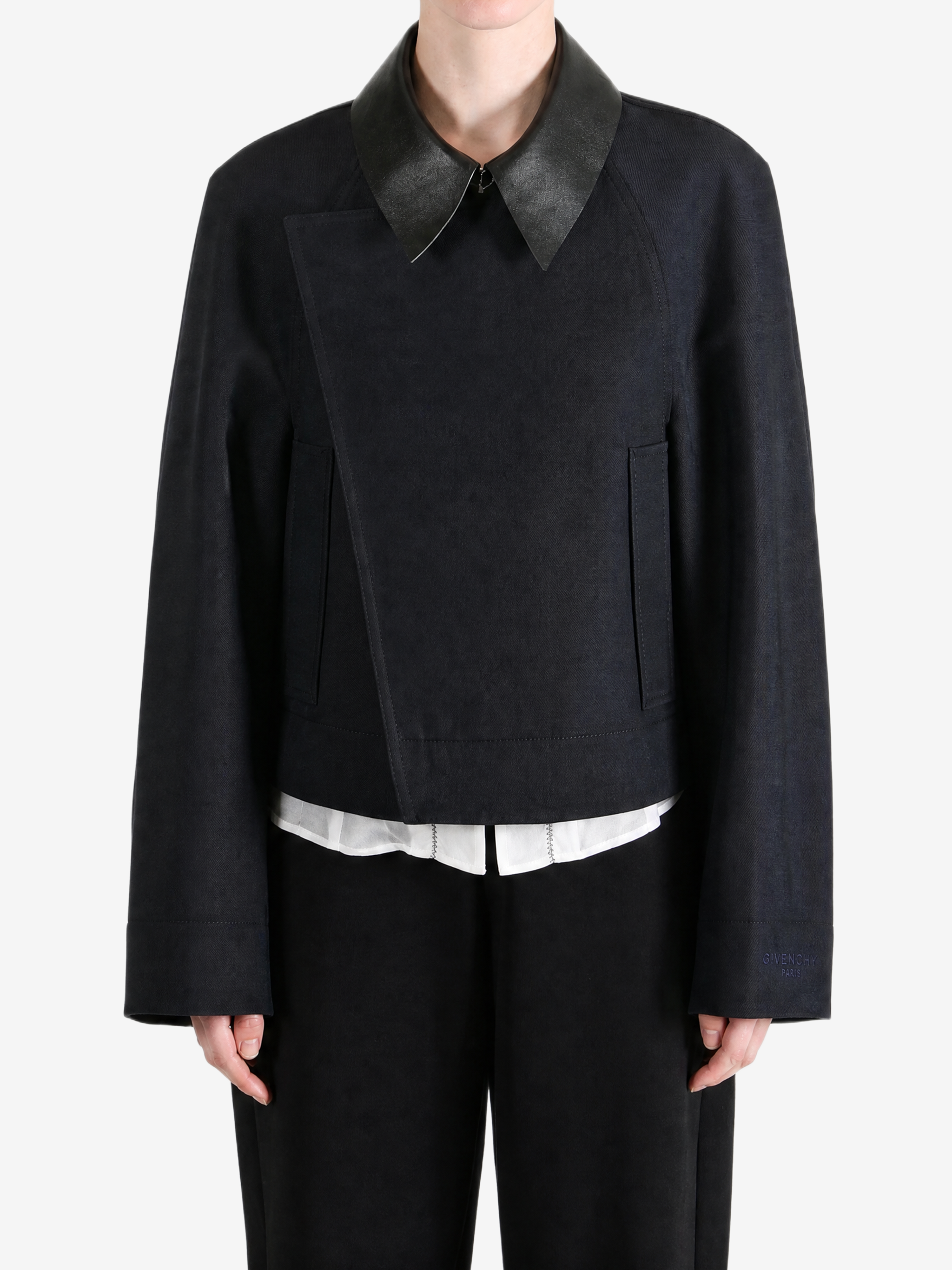 Black jacket worn by a person, showing the jacket fit