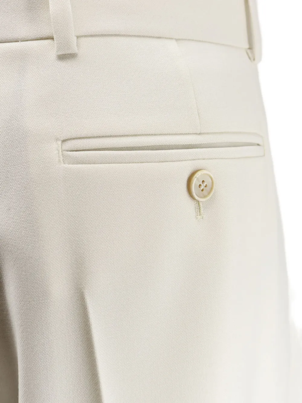 Close up of white pants, showing texture of the wool fabric