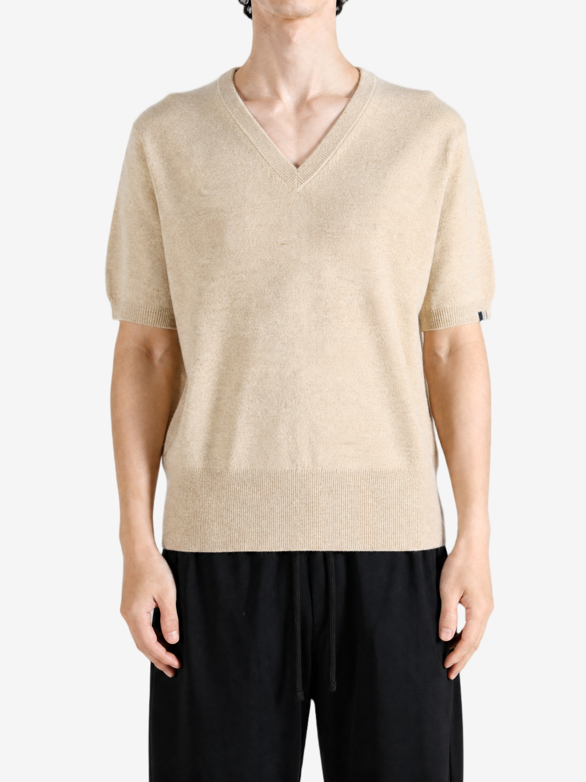Tan hoodie worn by a person, showing the hoodie fit