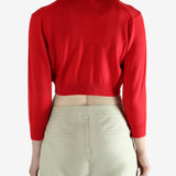 Red cardigan worn by a person, showing the cardigan's fit