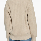 Tan sweater worn by a person, showing the sweater's fit
