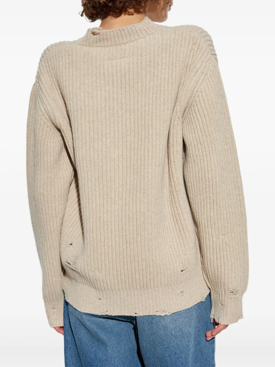 Tan sweater worn by a person, showing the sweater's fit