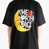 Black tee worn by a person, showing the tee fit