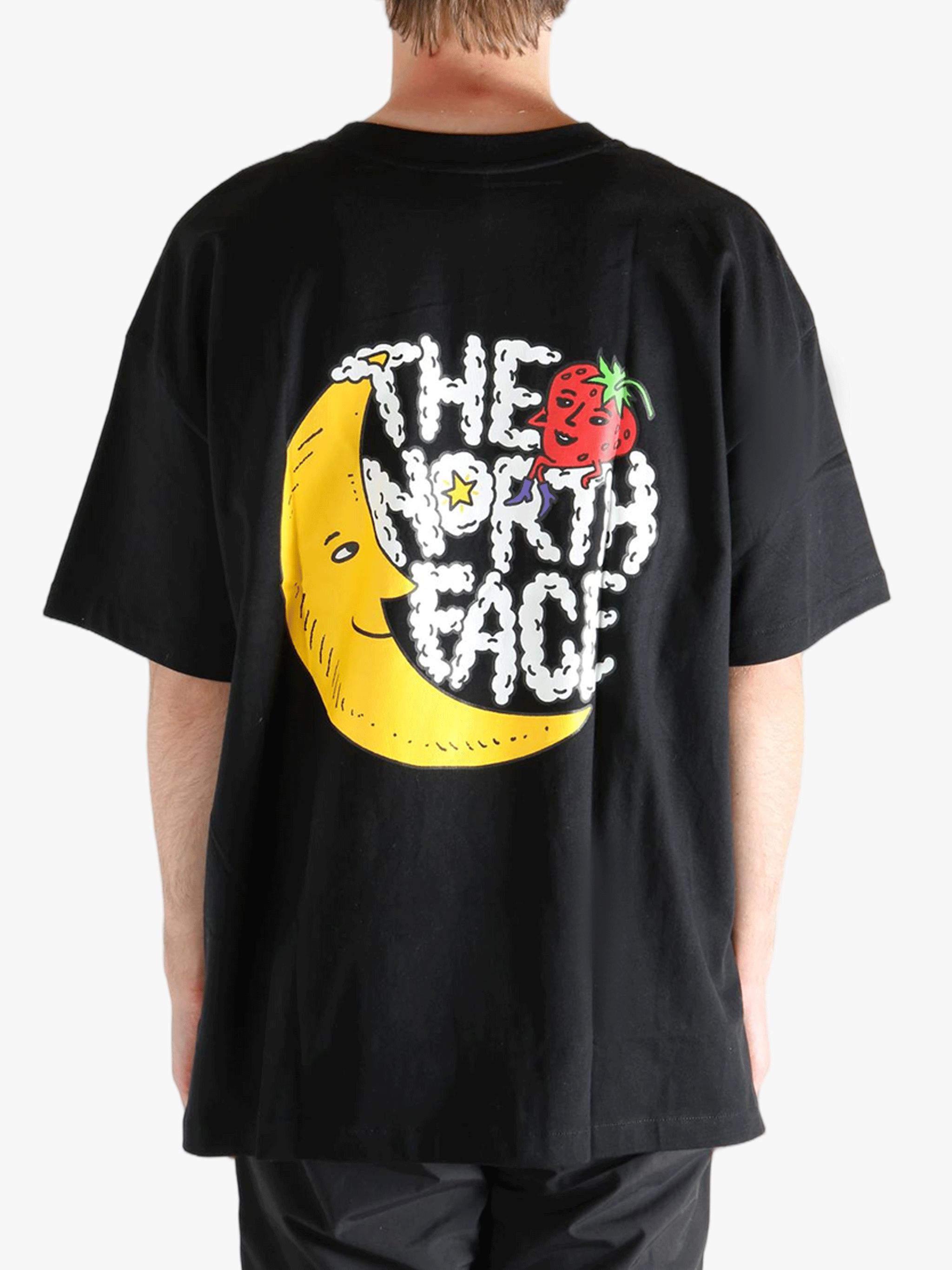 Black tee worn by a person, showing the tee fit