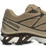 Close up of tan sneakers,showing texture of the rubber fabric.