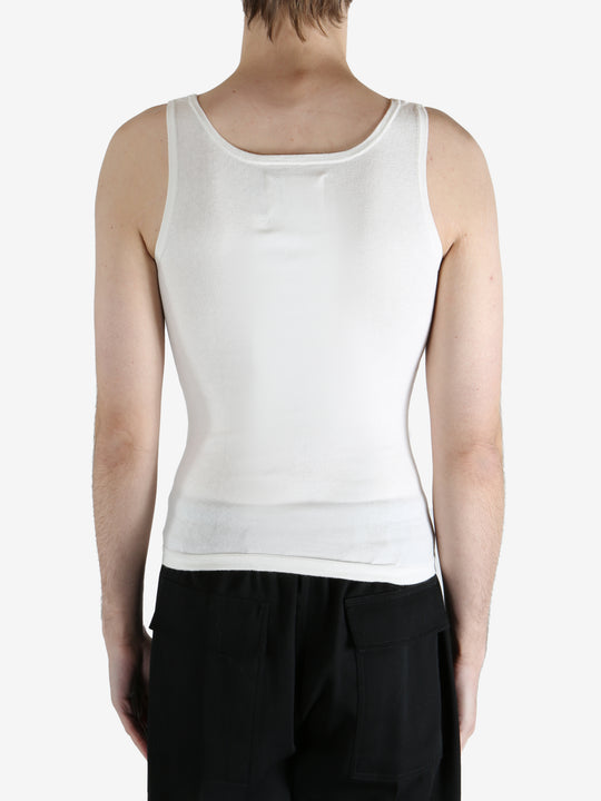 White tank worn by a person, showing the tank fit