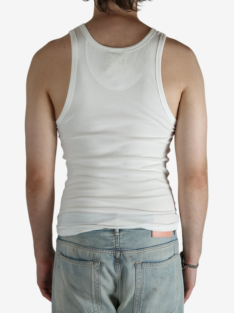 White top worn by a person, showing the top's fit