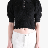 Black sweater worn by a person, showing the sweater fit