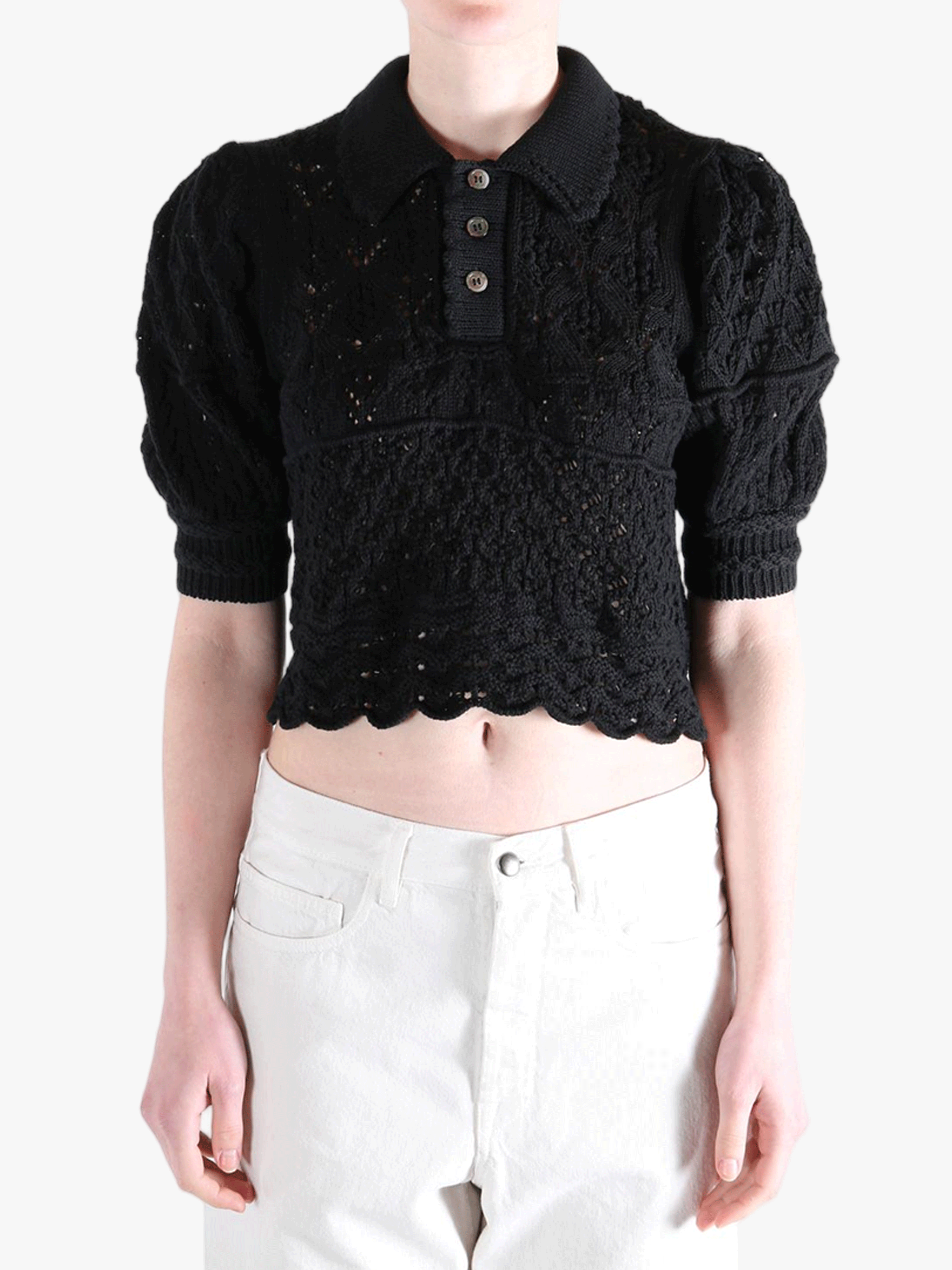 Black sweater worn by a person, showing the sweater fit