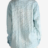 Blue shirt worn by a person, showing the shirt's fit