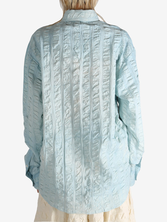 Blue shirt worn by a person, showing the shirt's fit