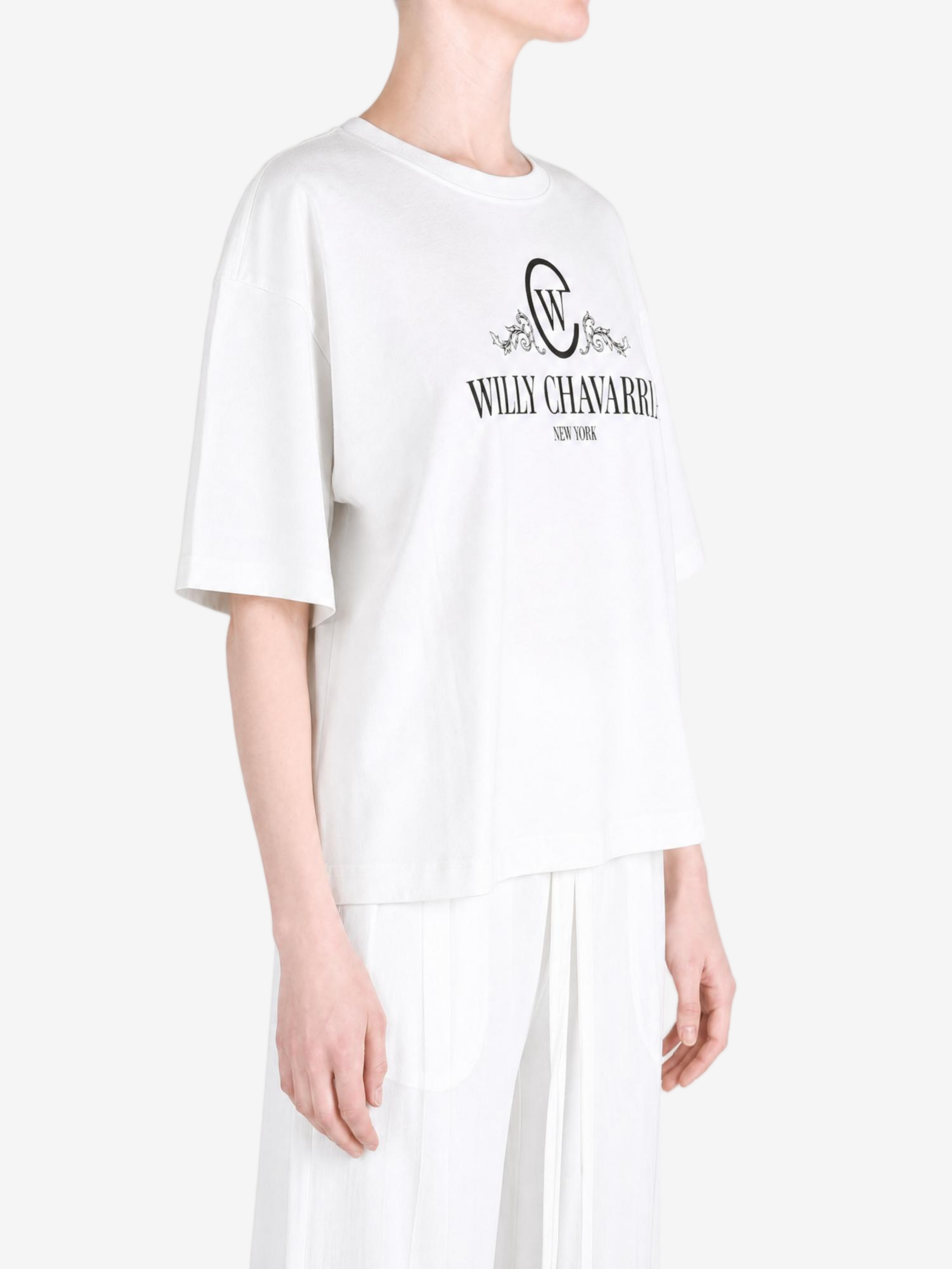 White t-shirt worn by a person, showing the t-shirt fit