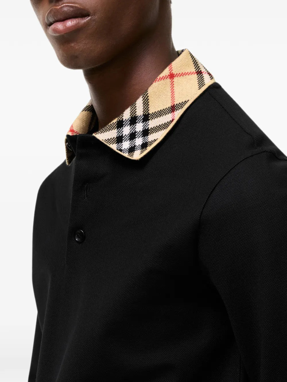 Black top worn by a person, showing the top fit