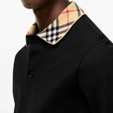 Black top worn by a person, showing the top fit