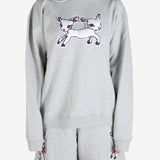 Grey knitwear worn by a person, showing the knitwear's fit