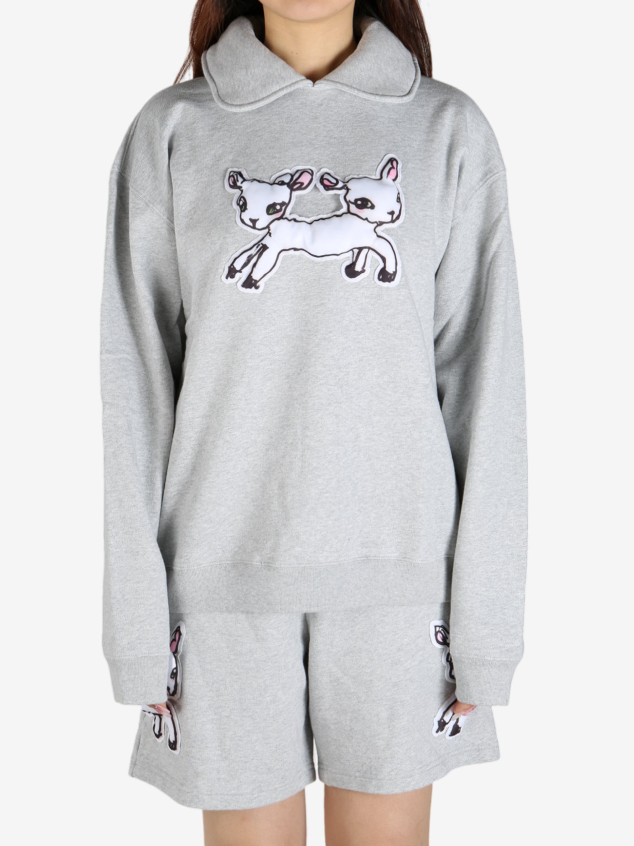 Grey knitwear worn by a person, showing the knitwear's fit