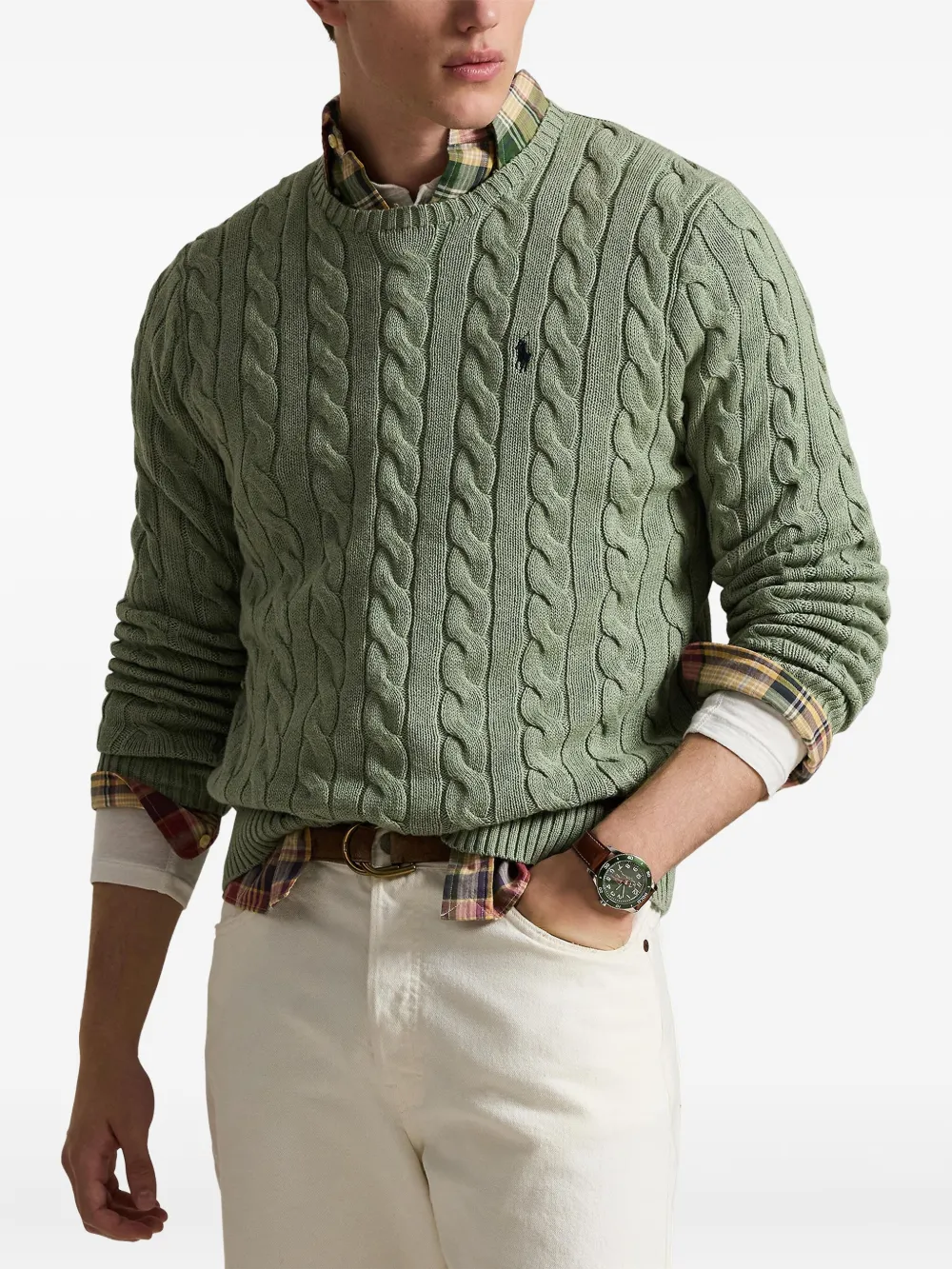 Green knitwears,worn by a person, showing the knitwears fit