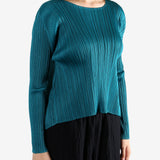 Green top worn by a person, showing the top fit