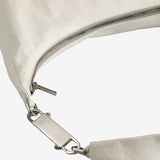 Close up of the white bag, showing texture of the leather fabric