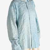 Blue shirt worn by a person, showing the shirt's fit