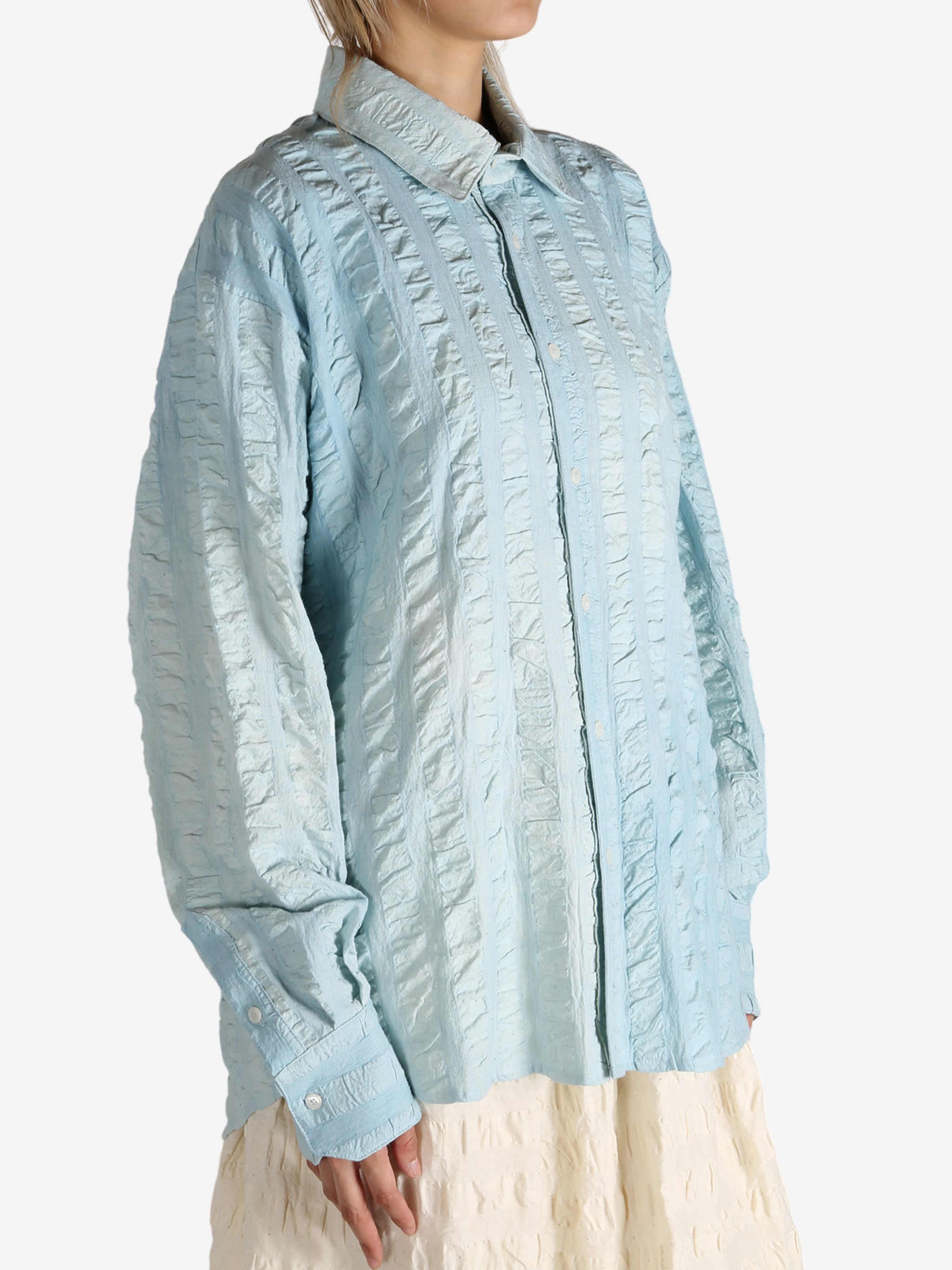 Blue shirt worn by a person, showing the shirt's fit