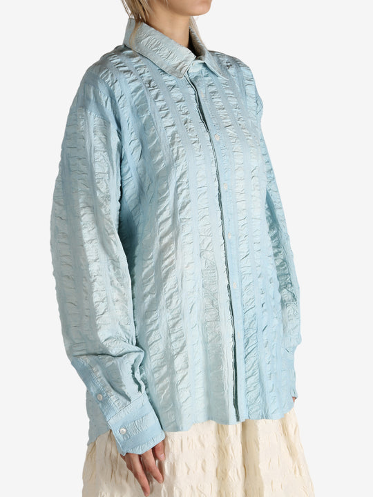 Blue shirt worn by a person, showing the shirt's fit