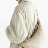 Tan bag worn by a person, showing the bag fit