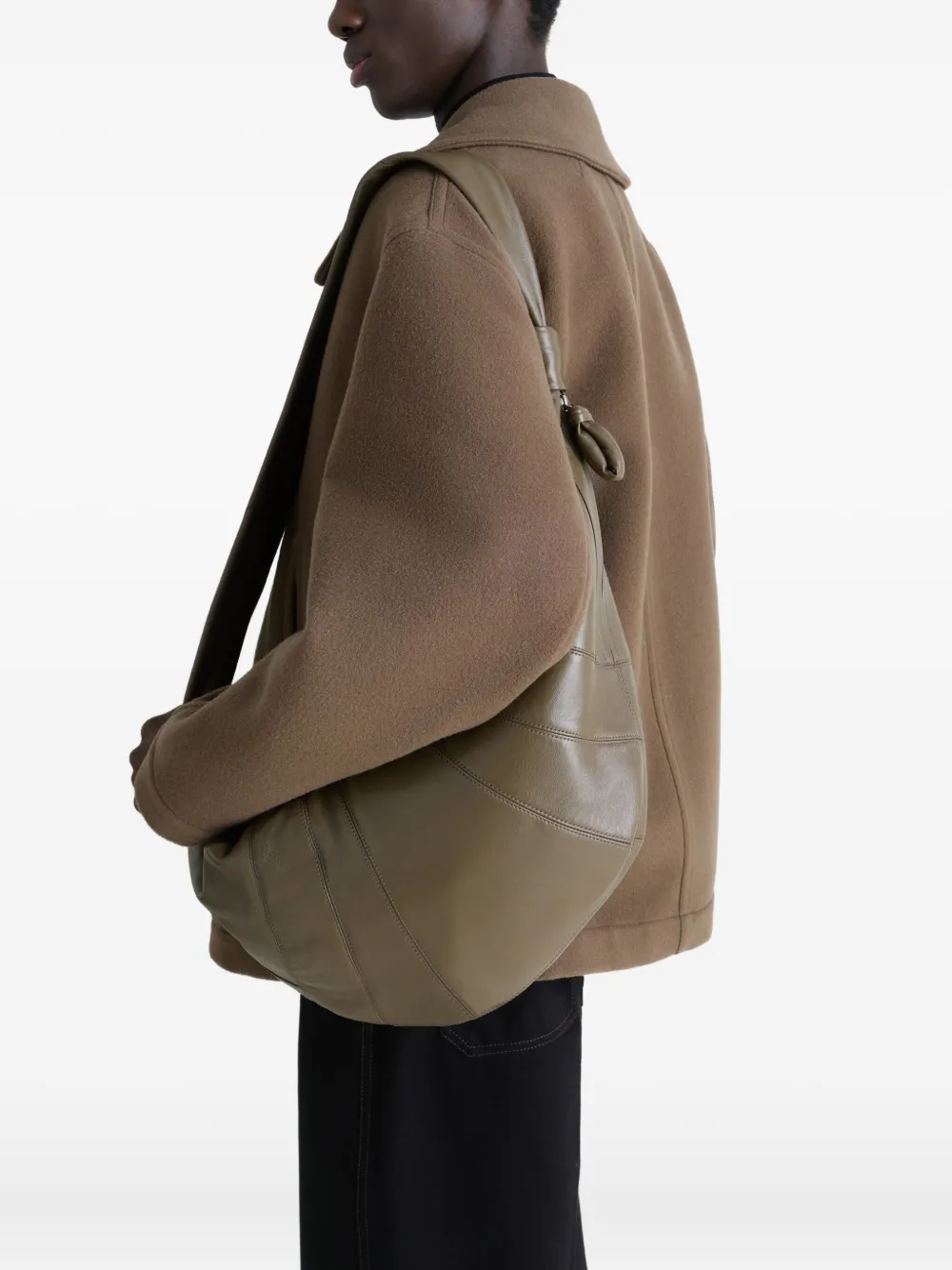 Green bag worn by a person, showing the bag's fit