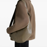 Green bag worn by a person, showing the bag's fit