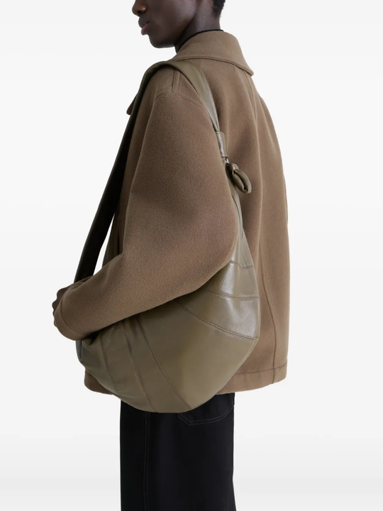 Green bag worn by a person, showing the bag's fit